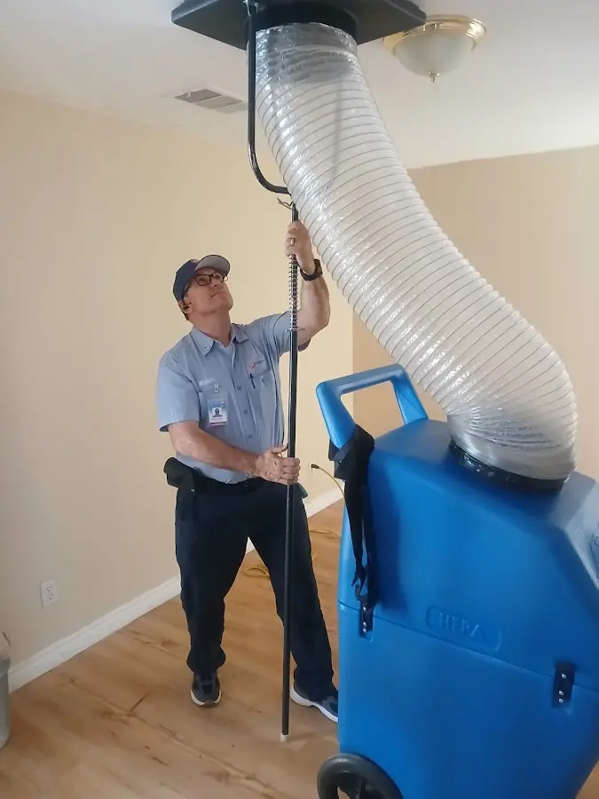 Furnace Tune-Up technician using HEPA equipment in Champaign